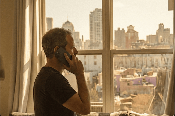 Modern San Francisco apartment interior with large window overlooking the Golden Gate Bridge and city skyline